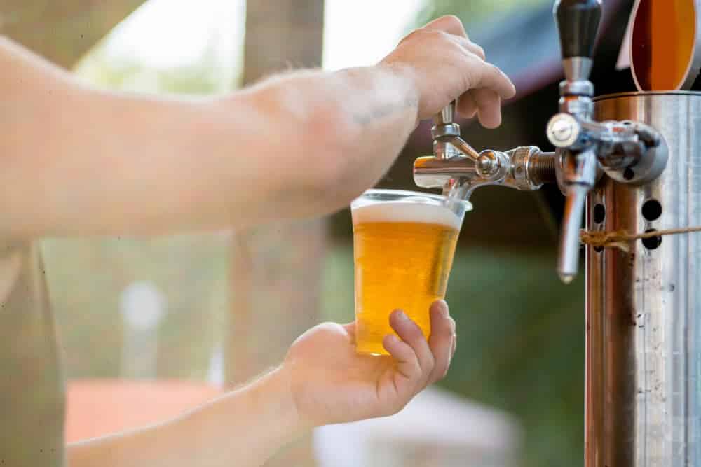 Waiter is Refilling the Class for Intoxicated Client