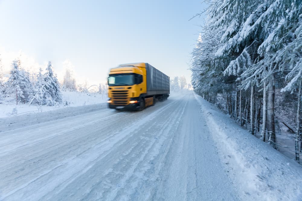A truck on the road in snow season