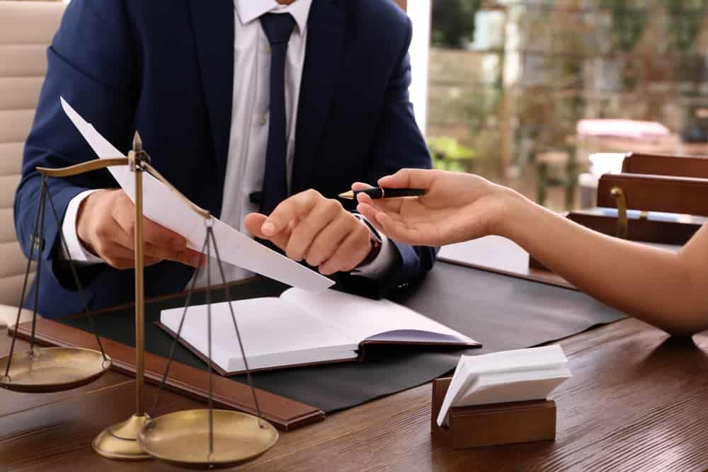 Lawyer working with client at table in office